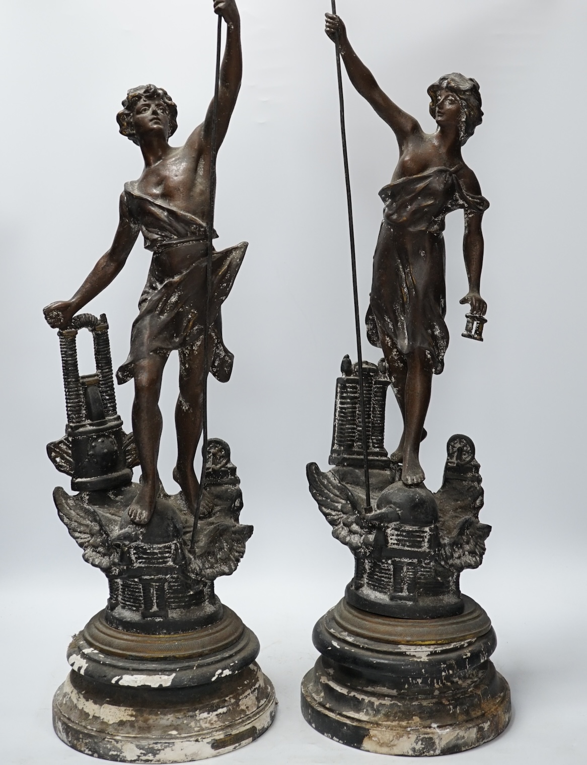 A pair of late 19th century, spelter classical figures on stands, tallest 78cm high